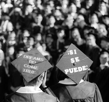 Graduates with messages written on their square caps.
