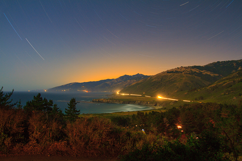 A 45-minute long record of the light in Big Sur. The headlights on Highway 1 wrap around the edge of the Central Coast from the campfires of the Plaskett Creek Campground (foreground) extending to the Pt. Sur Lighthouse (last light on the left). Stars streak in arcs around Polaris with the orange city lights of the Monterey Peninsula glowing over the Santa Lucia Mountains. 