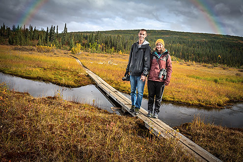 Rainbow arching over a couple enjoying an Alaskan vacation. 