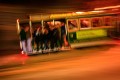 The Powell Street Trolley zooms down the hills of San Francisco overflowing with passengers with the night lights streaking past.