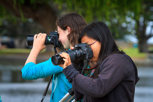 Two young students photographing.