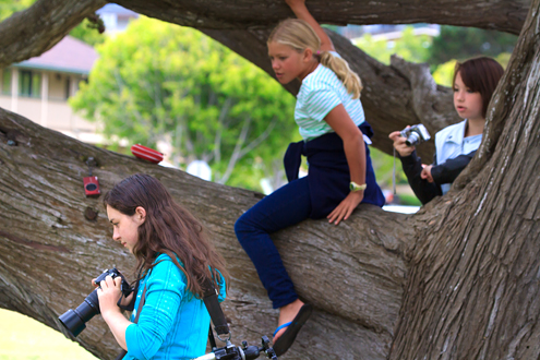 Three girls at the Lyceum Photo Camp playing in a tree.