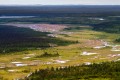 Snow melting across a tundra and forest landscape.