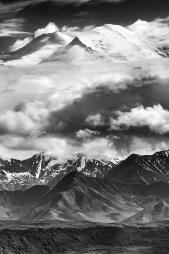 Mt. Denali is lost in the clouds most of the time but occasionally peaks out for a few minutes before hiding again. Just the sight of the Alaska Range Mountains is impressive, but when a massive mountain peaks out way up in the heavens above them, it’s surreal! 