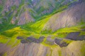 Abstract aerial photo of green and purple mountains.