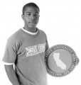 Confident male student holding a round CSUMB logo.