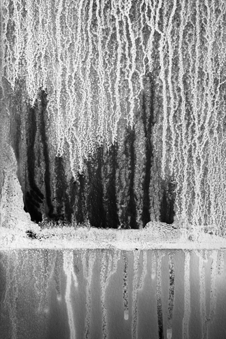 An enchanted forest in winter reflecting off a frozen pond is the scene I saw inside a condemned Fort Ord building used by fire departments for training. This is the result of papers pinned to the former army office wall burning, creating soot, and being extinguished by sprays of water. It also reminds me of the rare coastal oak woodland being threatened by development just a few blocks away. 