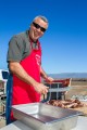 BBQ chef carves up ribs.