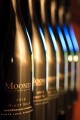 Close-up of black and gold Pinot Noir bottles falling out of focus.