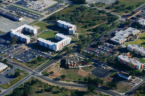 Aerial view of CSUMB’s residence halls and visitors center, and the intersection of General Jim Moore Boulevard and Intergarrison Road. 