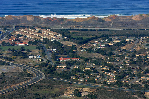 Aerial view of Fort Ord Dunes State Park fronted by Highway 1, Imjin Parkway, the Cypress Knolls redevelopment area of the former Fort Ord. 