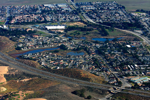 Aerial view of the City of Marina’s western area including Locke-Paddon Park, vernal ponds, Marina Library, and Marina Landing Shopping Center. 