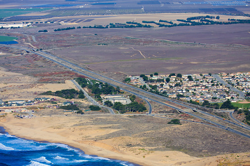 Aerial view of Marina State Beach, Dunes Drive, Highway 1, northern Marina, and Armstrong Ranch 