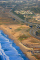 Coastal freeway wraps around a Monterey Bay beach.