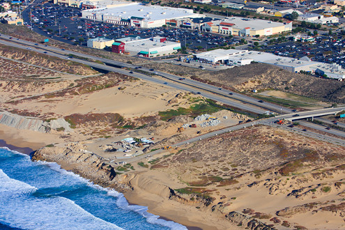 Aerial view of Sand City’s beach and shopping center with Highway 1, Tioga Avenue overpass and Playa Avenue underpass beach accesses. 