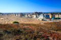 Wide angle view of The Dunes Housing Development with the ocean in the background and a hotel under construction.