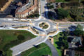 Aerial photo of trucks and cars traveling through a roundabout.