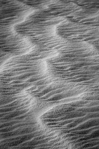 A wind-blown and water carved coastal sand dune. Part of a black and white portfolio of landscape and abstract nature photographs depicting Science Fiction-like imagery from distant galaxies to Earth’s prehistoric natural history. 