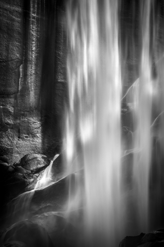 Sunlight reflecting off a canyon wall and lighting up the falling water. Part of a sci-fi black and white photography portfolio depicting life on distant worlds, fractals on a scale from galaxies to ice crystals, and how a 1,000-year-old redwood tree perceives the world. 