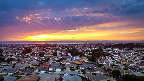 Aerial photo of Marina residential neighborhood with sunset over the Monterey Bay from a drone. 