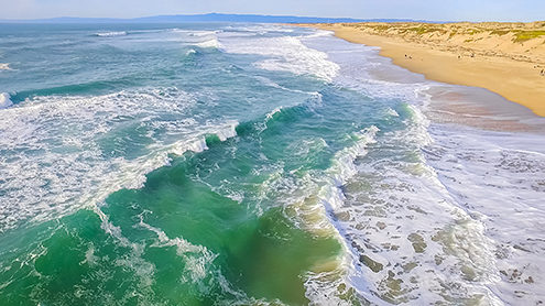 Flying above the emerald surf on a late afternoon. FAA certified sUAS/Drone photography. 