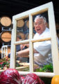 Chef Todd goofing off in front of a rustic window stage prop.