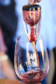 SLH Pinot Noir being aerated as it pours into a Santa Lucia Highlands Wine Artisans logo wine glass.