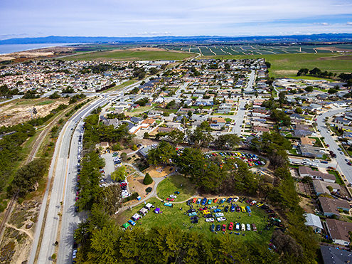 The Marina Rotary’s annual Cars in the Park event at Vince DiMaggio Park with the northern side of Marina and strawberry fields in the background. FAA certified commercial sUAS/Drone photography. 