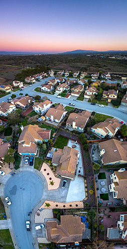Track homes at the edge of the City of Marina with the UC Santa Cruz Preserve and Mt. Toro in the background at sunset. This is a vertirama with 9 photos stitched together vertically covering 0° to 90°. FAA certified commercial sUAS/Drone photography. 