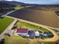 Aerial photo from about 200 feet above a River Road Wine Trail Valentines Passport festivities with vineyards and mountains in the background.