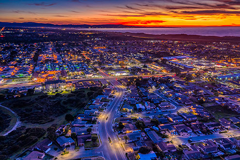 400 feet above the City of Marina from a drone with an 8-second exposure with the Fort Ord Dunes, Monterey Bay and Monterey Peninsula in the background. 