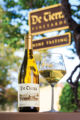 Wine bottle product shot with full wine glass and downtown Carmel-by-the-Sea background.