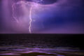 Photo of lightning over the ocean that illustrates the raw power of nature