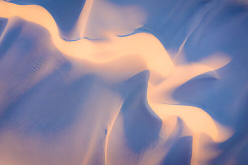 Abstract of warm sunrise light and cool shadows mix and blend across sand dunes. Z Photo Game Card No. 47 